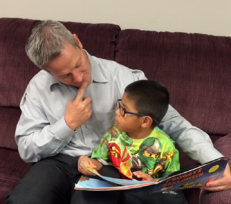 matt-timmy and a boy reading the book Froggy's Halloween